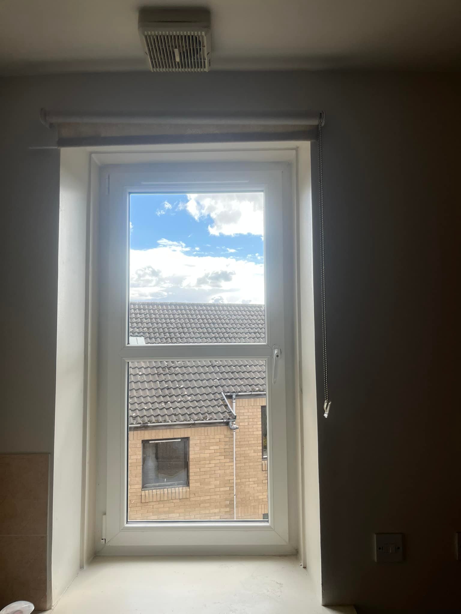 Narrow Case window looking out to another house
