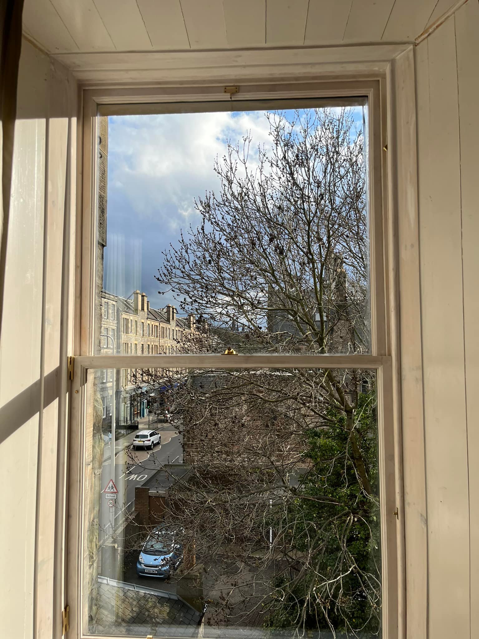 Sash windows looking out to city in the sun shine