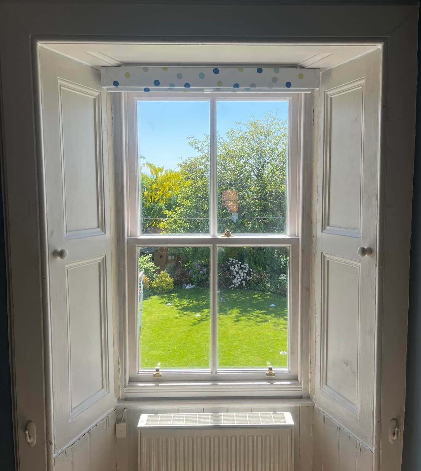 Sash windows with bright summer garden